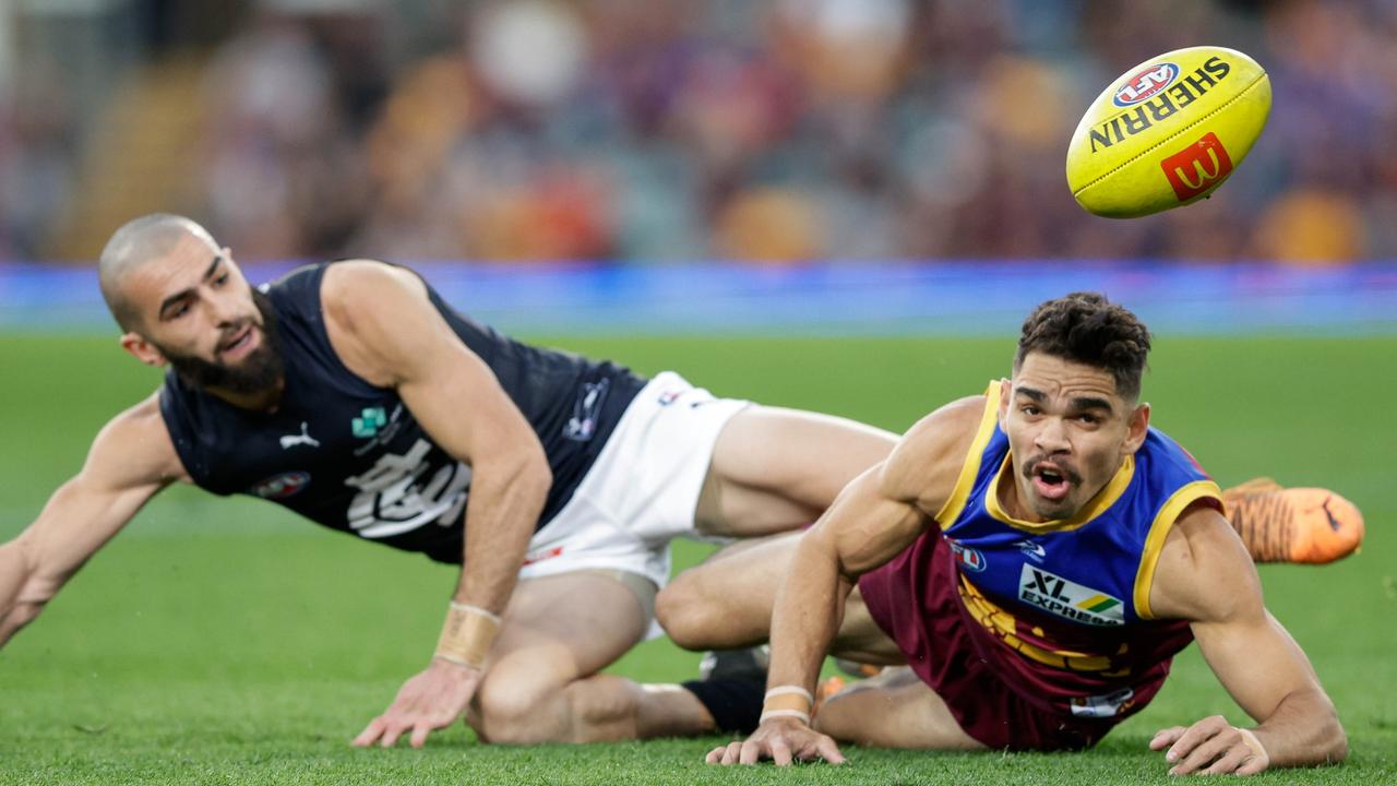 Charlie Cameron and Adam Saad battle for a loose ball. Picture: Russell Freeman/AFL Photos via Getty Images