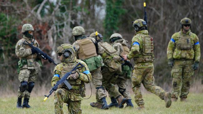 Members of the Australian Armed Forces and Ukrainian soldier train together during a visit by Richard Marles and Penny Wong. Picture: AFP