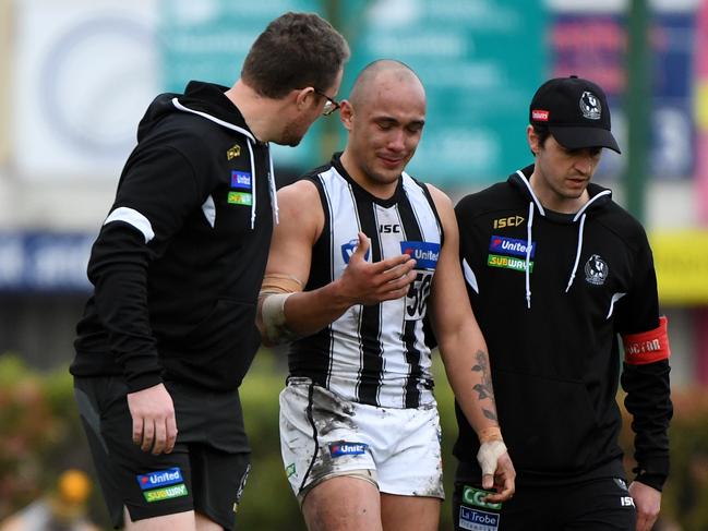 Alex Woodward in the hands of trainers. Picture: James Ross/AAP