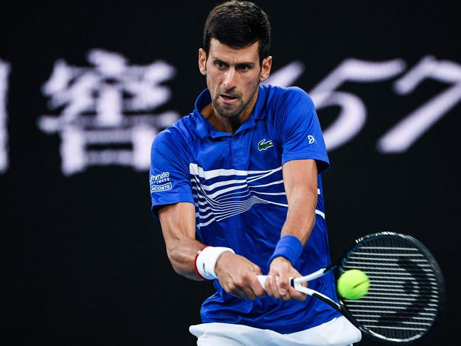 Serbia's Novak Djokovic hits a return against Japan's Kei Nishikori during their men's singles quarter-final match on day ten of the Australian Open tennis tournament in Melbourne on January 23, 2019. (Photo by Saeed KHAN / AFP) / -- IMAGE RESTRICTED TO EDITORIAL USE - STRICTLY NO COMMERCIAL USE --