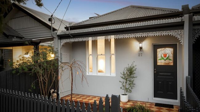 The stained glass door feature and picket fence makes for a charming facade.