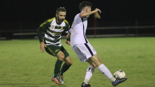 Western Pride captain Killian Flavin shadows his Brisbane City opponent during their recent match at the Briggs Road Sporting Complex. Picture: Kerryn Hyett