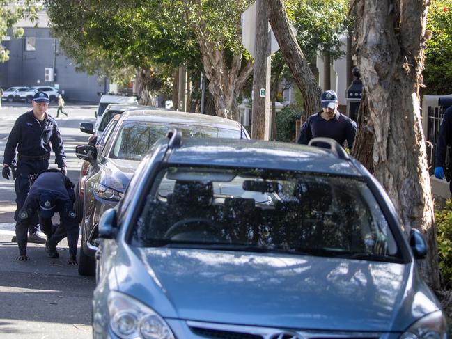 27-06-2023 - Police search surrounding streets for evidence after a burnt out vehicle was found in Zetland following a gangland linked shooting in Bondi Junction on Tuesday morning. Liam Mendes / The Australian