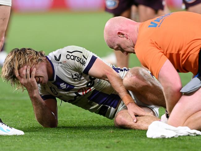 BRISBANE, AUSTRALIA - SEPTEMBER 08:  Ryan Papenhuyzen of the Storm is attended to by a team trainer after an ankle injury during the NRL Qualifying Final match between the Brisbane Broncos and Melbourne Storm at Suncorp Stadium on September 08, 2023 in Brisbane, Australia. (Photo by Bradley Kanaris/Getty Images)