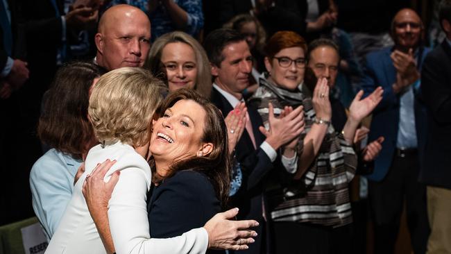 Jenny Morrison embraces Michaelia Cash watched on by Coalition MPs. Picture: Jason Edwards