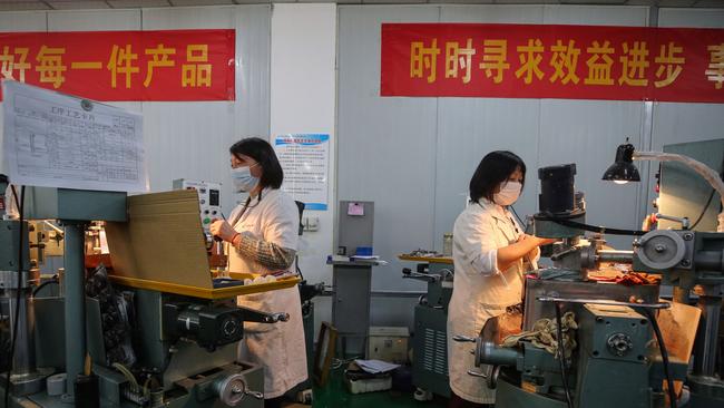 Employees working at a photoelectric production line at a factory in Wuhan in China's central Hubei province. Picture: AFP