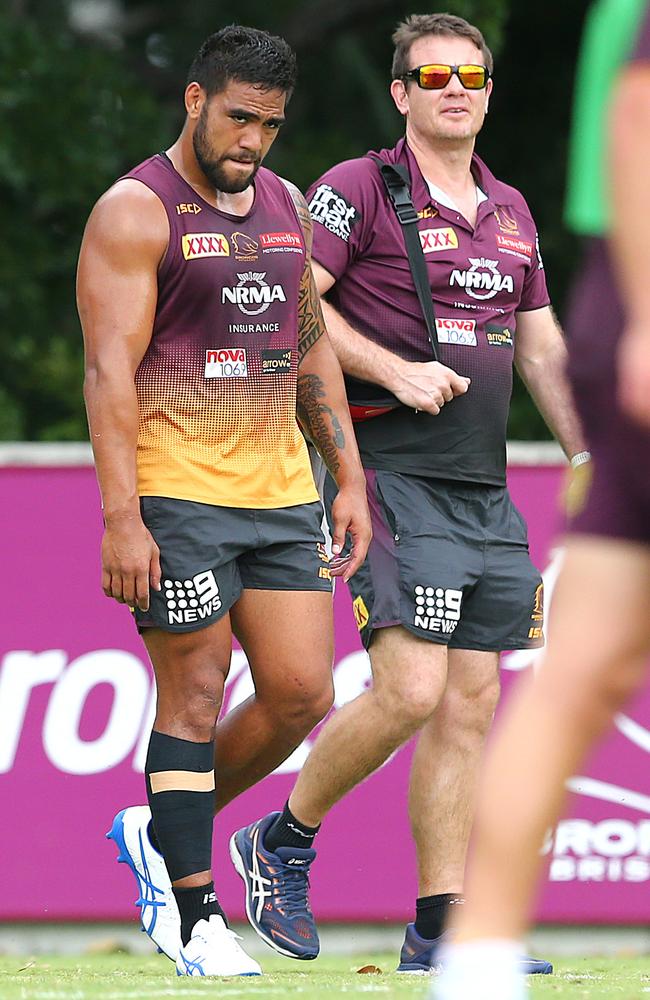 Joe Ofahengaue attempts to walk after having his leg looked at during Brisbane Broncos training. Picture: AAP Image/Jono Searle