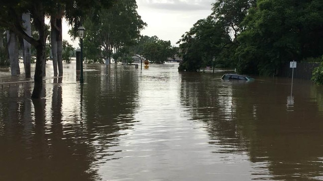 Flooding in Maryborough on Sunday morning, a car is submerged under the flood water. Picture: Robyne Cuerel