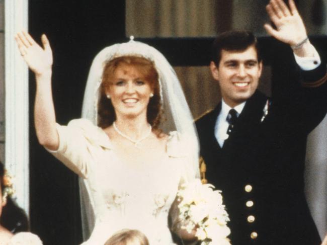 (FILE PIC)  The newly wed Prince Andrew, the Duke of York and his wife Sarah Ferguson, the Duchess of York, wave to crowds 23 July 1986 from the balcony of Buckingham Palace in London while Queen Elizabeth II and Queen Mother look on. Prince Andrew desperately wants to remarry his former wife Sarah but is being prevented from doing so by his mother Queen Elizabeth II, The Sun newspaper reported 18 October 1999 in London. (Photo by PA / AFP)