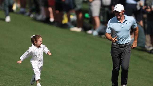 Rory McIlroy is pictured running on the seventh hole with his daughter, Poppy. Picture: AFP