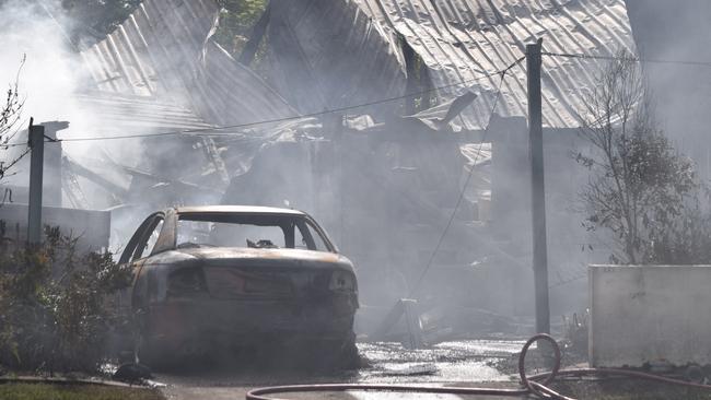 Smoke blankets the scene of the house fire in Mooney St that left two people fighting for life early on Boxing Day. Photo: Daniel Shirkie.