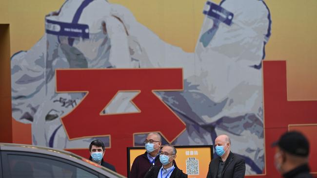 Members of the World Health Organization (WHO) team investigating the origins of the Covid-19 pandemic leave after visiting a museum exhibition about China's fight against Covid-19 in Wuhan.