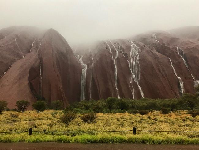 Heavy rain across the Northern Terrority created the rare sight of waterfalls down the sides of Uluru. Picture: James Holding/Twitter