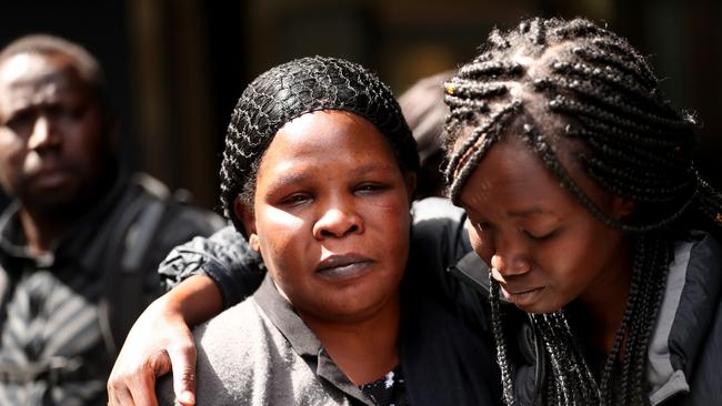 The mother of murder victim Laa Chol, Ojwanga Abalo, centre is comforted by friends and family leaving court in March this year. Picture: David Geraghty/The Australian. .