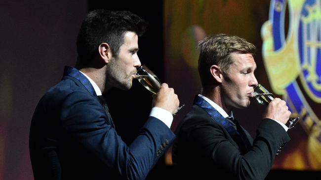 AFL players Trent Cotchin (left) and Sam Mitchell are seen on stage after they were presented their 2012 Brownlow medals.