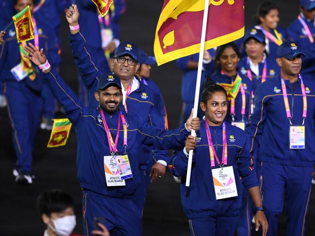 BIRMINGHAM, ENGLAND - JULY 28: Indika Dissanayake and Chamari Athapaththu, Flag Bearers of Team Sri Lanka leads their team out during the Opening Ceremony of the Birmingham 2022 Commonwealth Games at Alexander Stadium on July 28, 2022 on the Birmingham, England. (Photo by Alex Davidson/Getty Images)