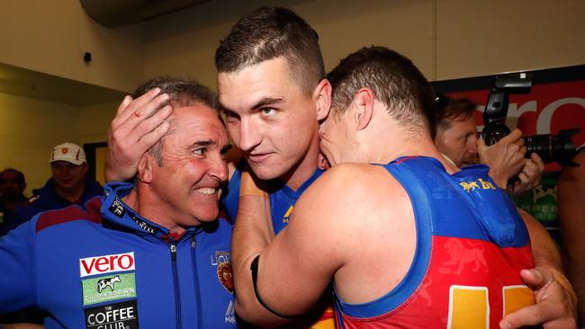 Chris Fagan, coach of the Lions, celebrates with Tom Rockliff (centre) and Dayne Zorko after beating Essendon at Etihad Stadium in July 2017. Picture: Getty Images