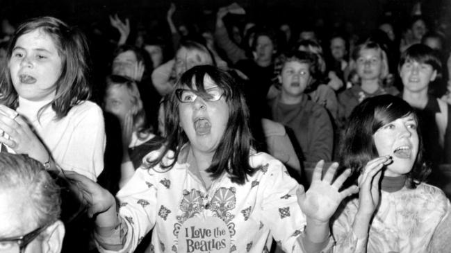 Fans at Sydney Stadium as band members arrive for 1964 Australian tour performance.