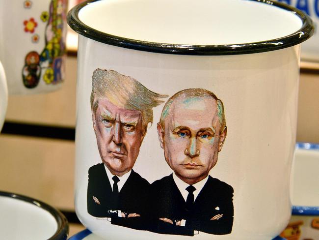 A tin mug depicting Russian President Vladimir Putin and US President Donald Trump sits on display in Moscow ahead of their July meeting. Picture: Mladen Antonov. AFP