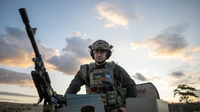 A Ukrainian soldier atop an Australian Bushmaster in Ukraine’s east. Picture: Liam Mendes