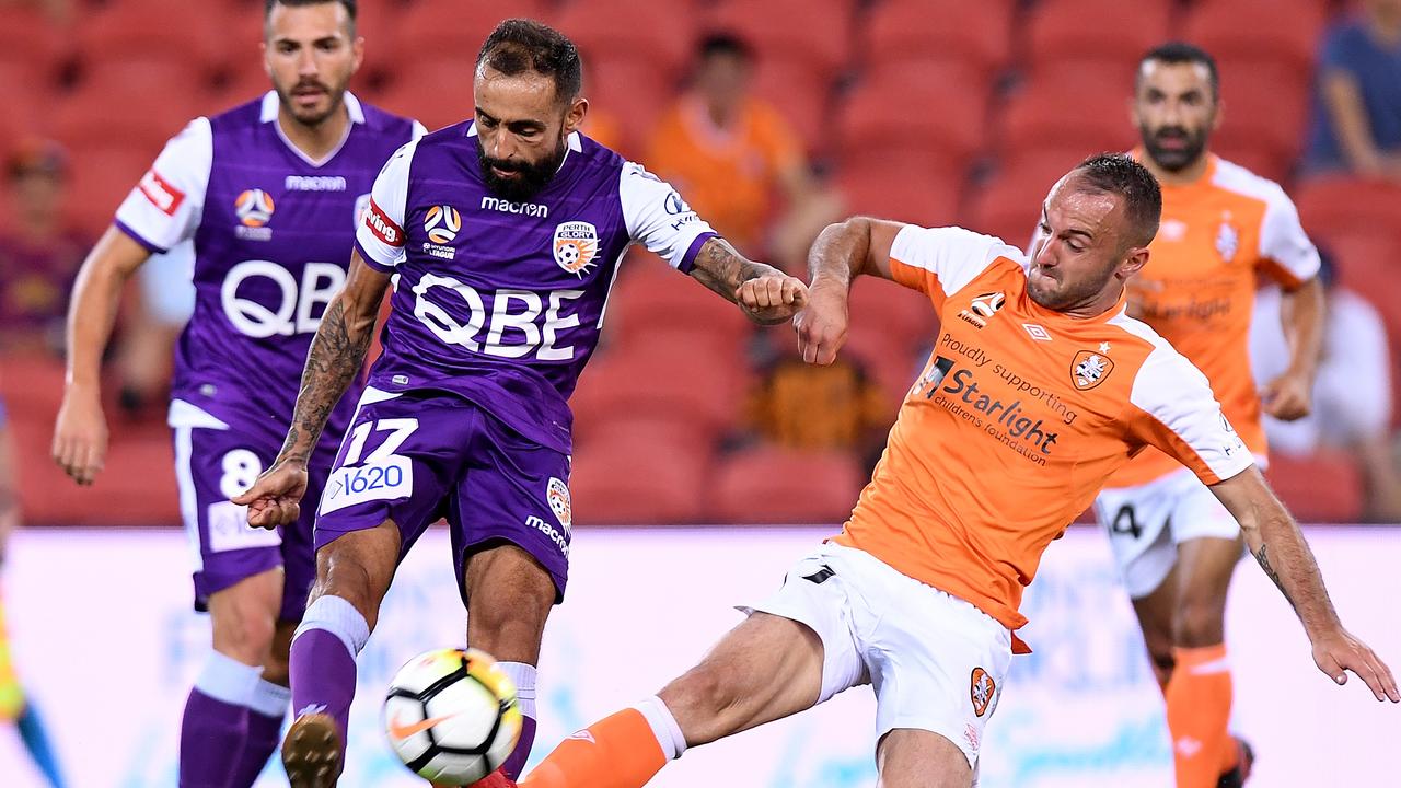 Diego Castro of the Glory is tackled by Ivan Franjic of the Roar during their round 17 A-League match.