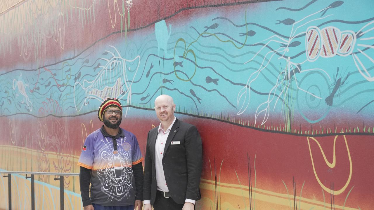 The new $10m National Australia Bank branch opens on Ruthven Street in the Toowoomba CBD. Indigenous artist David McCarthy is pictured with branch manager Steve Platen next to his mural as part of the launch.