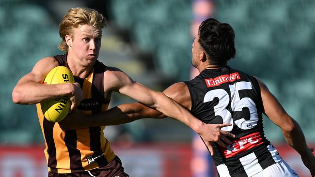 Cam Mackenzie gets past Nick Daicos in Hawthorn’s practice match. Picture: Steve Bell/Getty Images