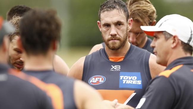 Shane Mumford listens to Leon Cameron during a pre-season practice match against Sydney.