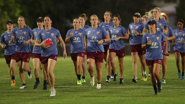 Brisbane’s AFLW team trains under lights.