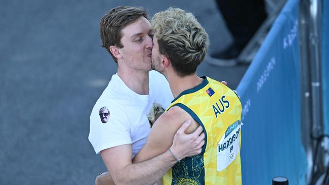 Harrison kisses his boyfriend Justin. Photo by Jonathan NACKSTRAND / AFP