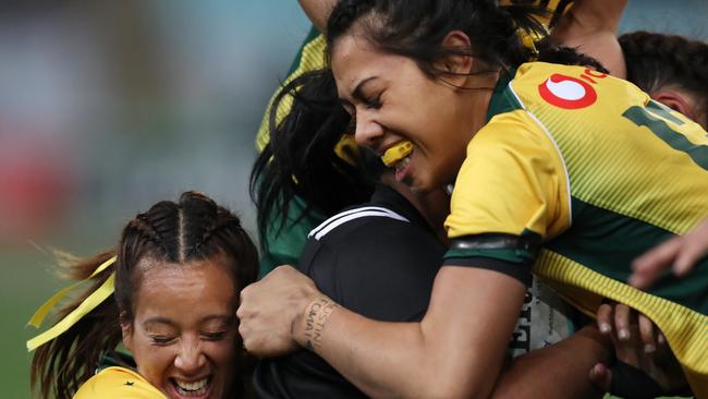 Australia's Mhicca Carter, left, and Atasi Lafai making a tackle for the Wallaroos against New Zealand before Lafai was injured.