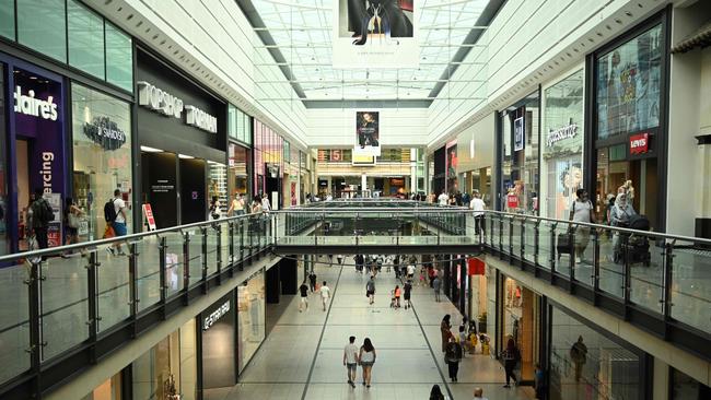 Shoppers walk around the Arndale Centre in Manchester which is back into lockdown. Picture: AFP.