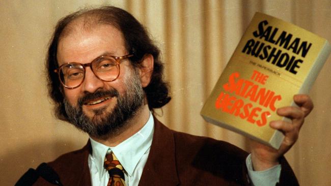 Salman Rushdie holds up a copy of The Satanic Verses during a 1992 news conference in the US at Arlington, Virginia. Picture: AP Photo/Ron Edmonds