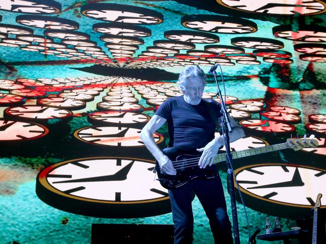 A giant screen displaying playing footage of animated clocks plays behind Roger Waters during his first night at Brisbane Entertainment Centre during the Us + Them tour. Picture: AAP Image/Steve Pohlner