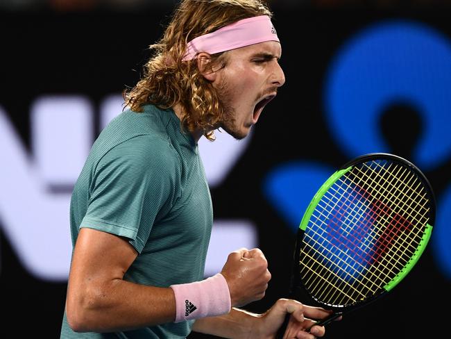 Stefanos Tsitsipas roars as he takes another point against Switzerland's Roger Federer during his upset victory on Sunday night. Picture: AFP