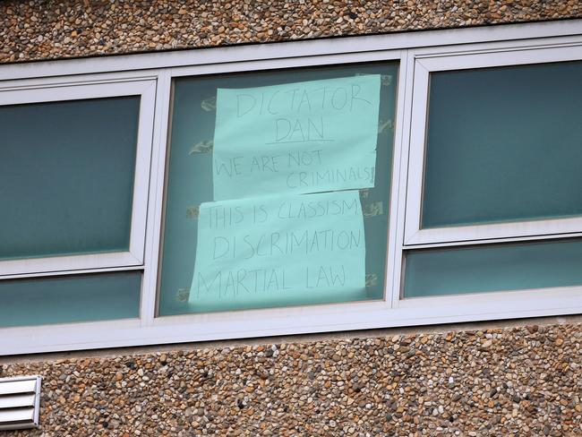 Police block off all entry ways to the housing commission towers on Flemington Rd and Holland Crt. Sign in the window of one of the flats at 120 Flemington Rd Tower. Picture: Sarah Matray