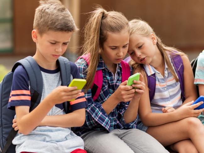 Children using smartphone devices at school. Picture: iStock.