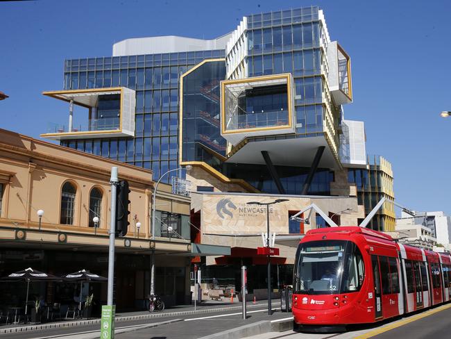 A tram goes past the University of Newcastle’s Hunter street campus. Picture: File / AAP