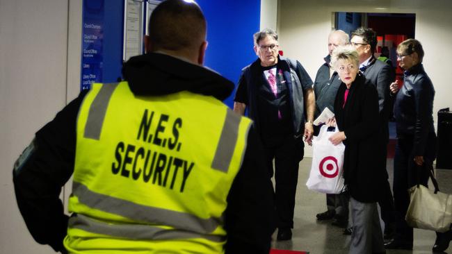 Security guards escort residents from the fayer to the council chambers. Pic Jenny Evans