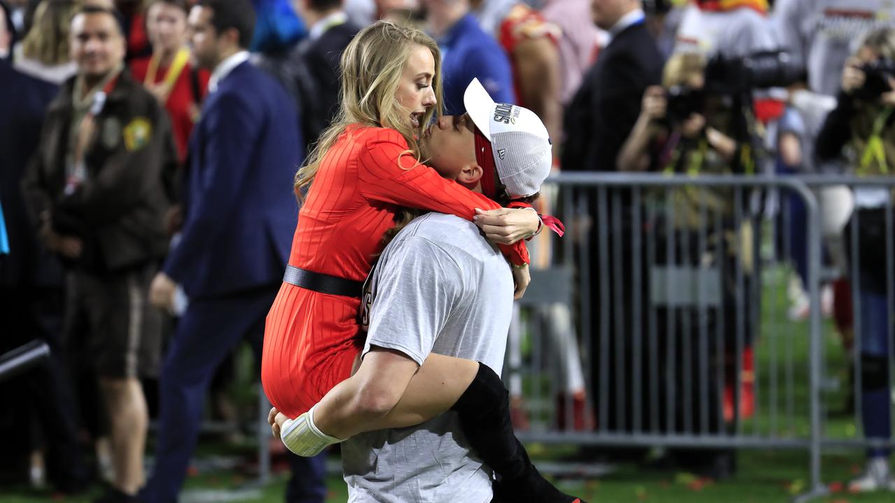 Brittany Matthews sprays champagne during Chiefs playoff win