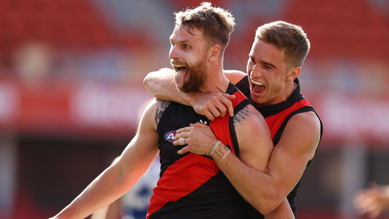 AFL Round 18. North Melbourne vs Essendon at Metricon stadium, Gold Coast . 18/07/2021. Jake Stringer of the Bombers celebrates with Matt Guelfi after kicking a last qtr goal . Pic: Michael Klein