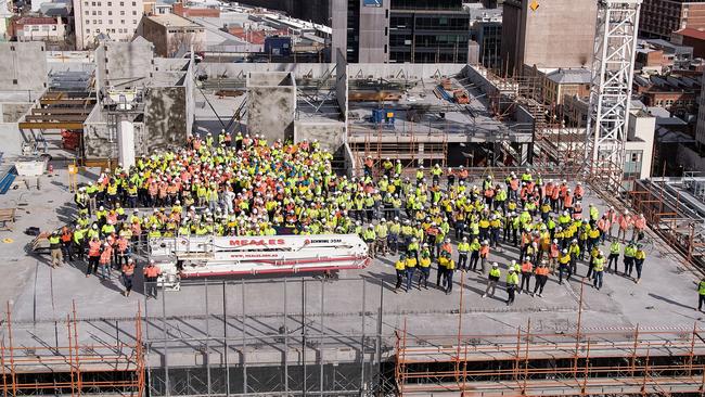 More than 500 construction workers gather on the top of the Royal Hobart Hospital K-Block after the main concrete structure was completed this week.