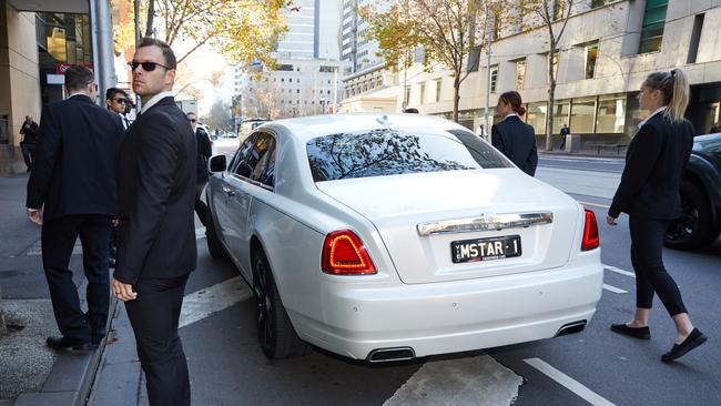 He arrived at court in a hired limousine, with actors playing the part of his security posse.