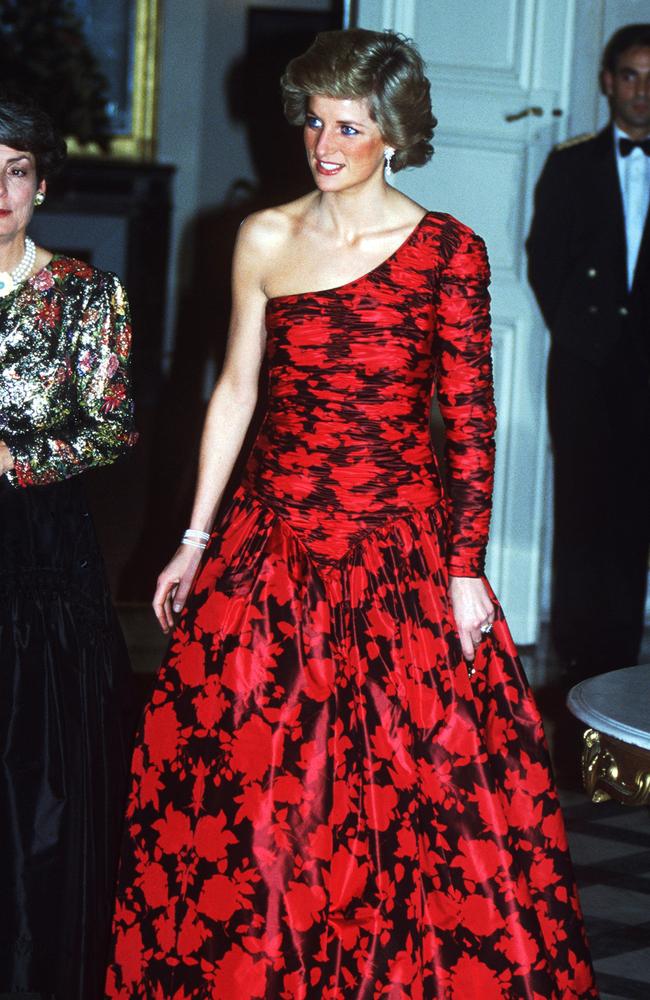 Diana’s Style: 1988 - The Princes of Wales, wearing a red and black Catherine Walker evening dress, attends a dinner at the British Embassy in Paris during an official visit to France. Picture: Getty