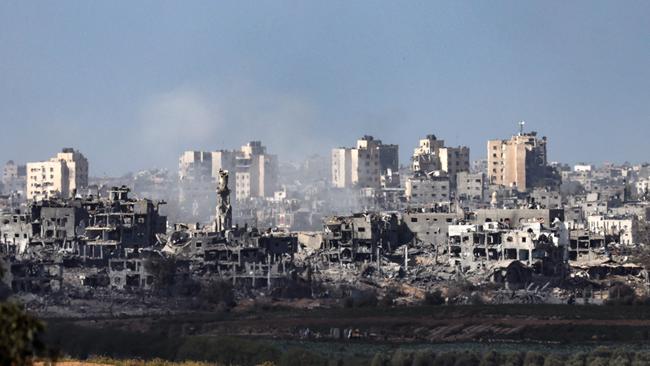 A picture taken from Sderot, along the border with the Gaza Strip, shows smoke rising behind destroyed buildings in the Palestinian enclave. Picture: AFP