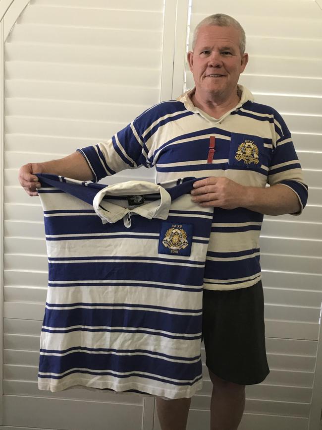 Tony D'Arcy with his Nudgee College jersey and that of his son, Christopher, who died aged 15.