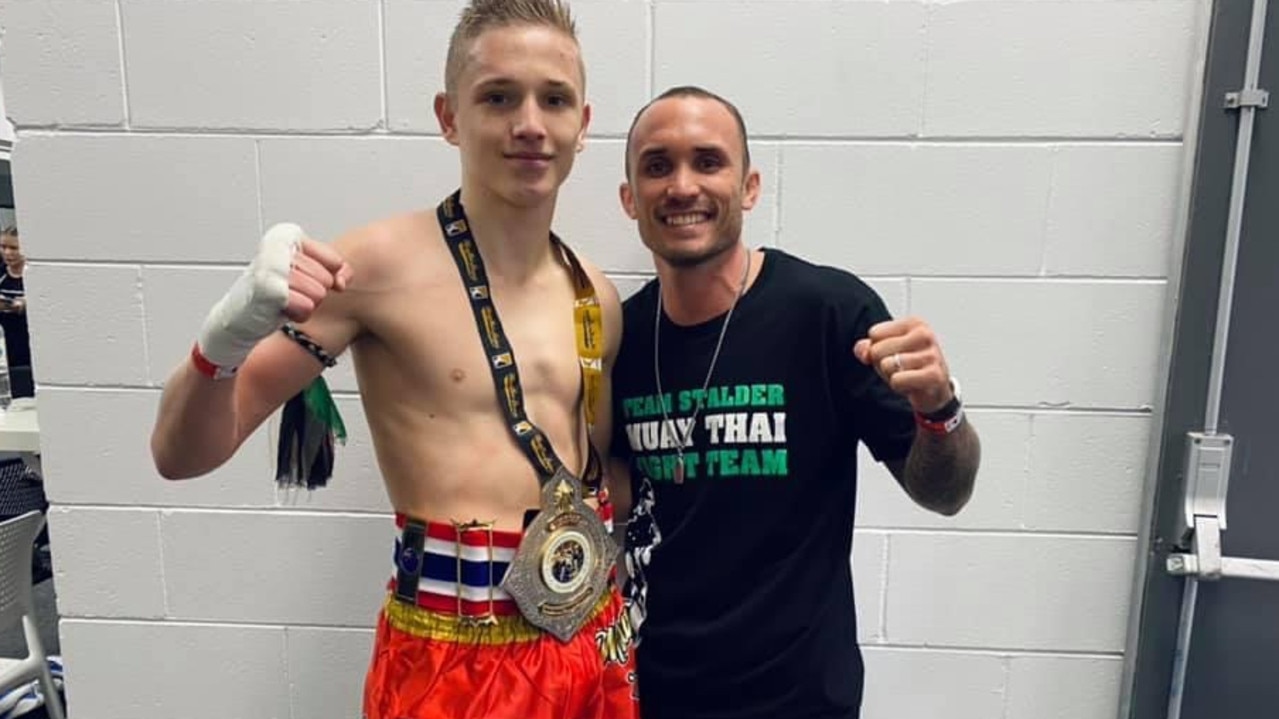 Dre Stalder with his father and coach Brodie Stalder after winning his title fight, crowning him the newest WMO Australian Champion. Picture: Contributed