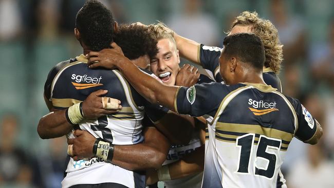 Henry Speight of the Brumbies celebrates with his teammates after scoring a try.