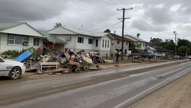 Residents have piled waterlogged possessions along Tweed Valley Way. Picture: Liana Walker