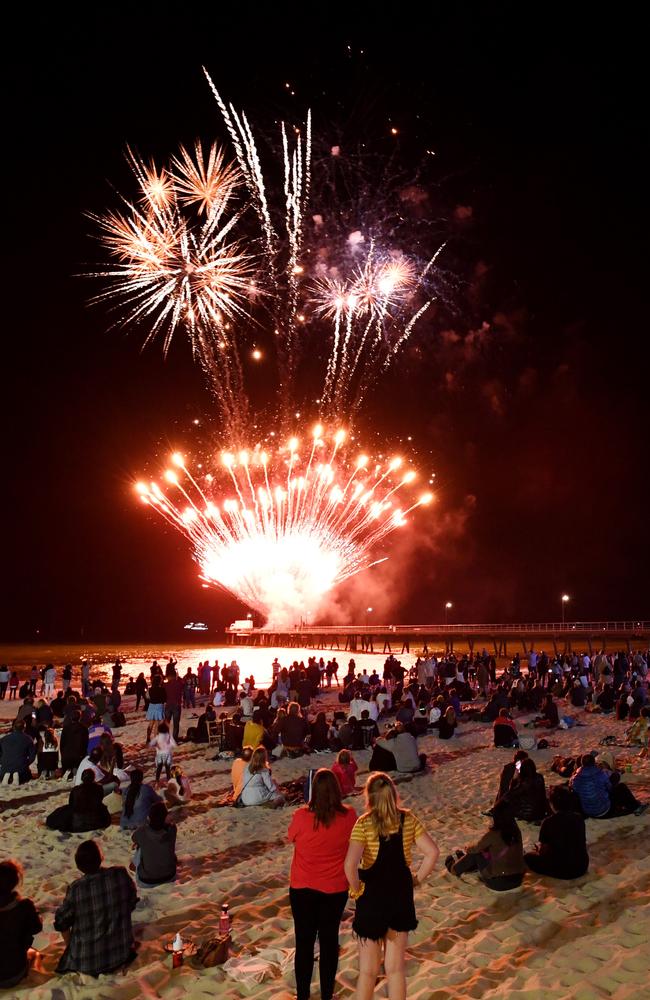 Revellers watch the 9.30pm fireworks on New Years Eve in Glenelg, Adelaide. Picture: Tracey Nearmy/Adelaide Advertiser